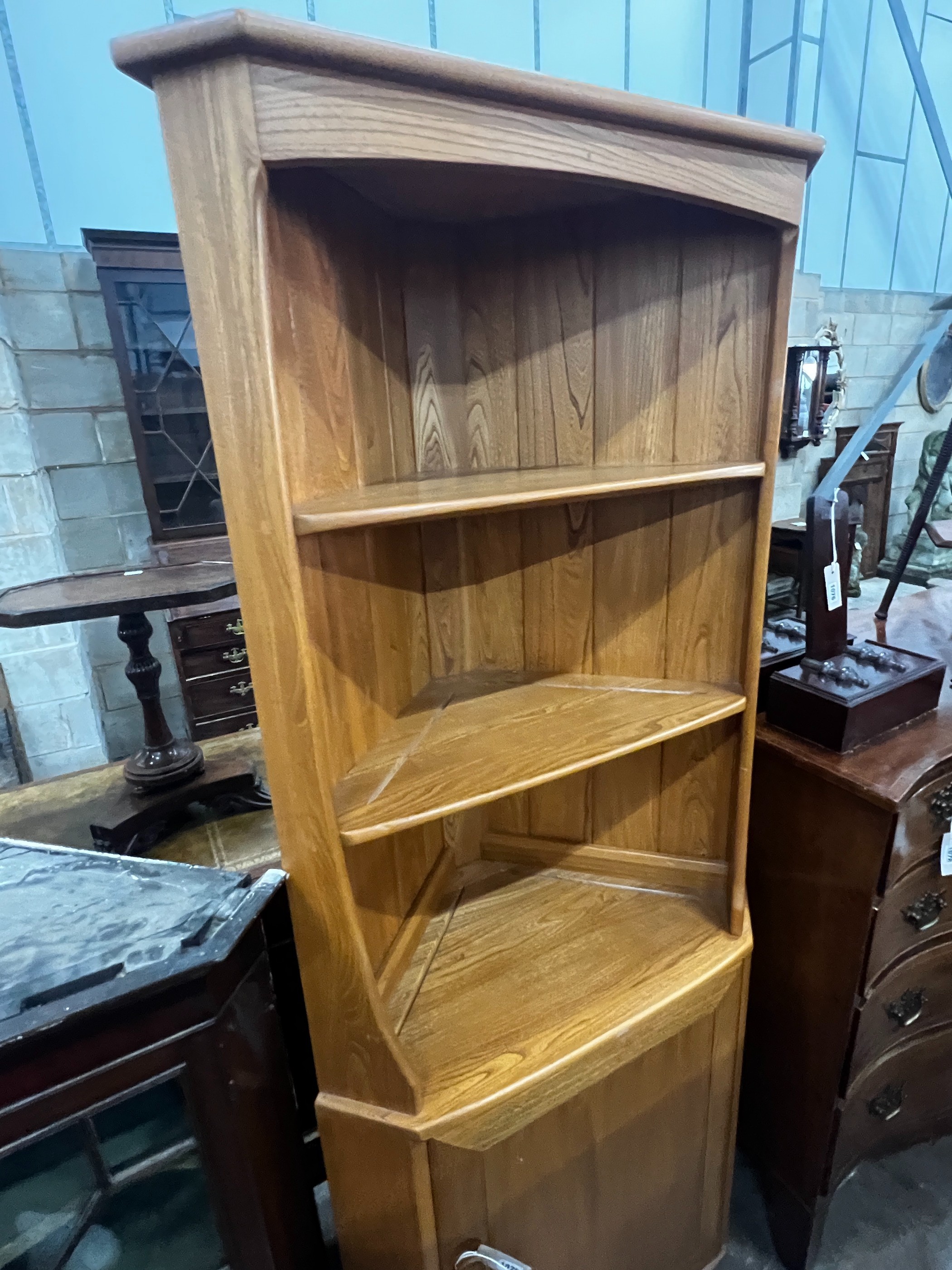 An Ercol elm 'Windsor' standing corner cabinet, width 73cm, depth 41cm, height 179cm